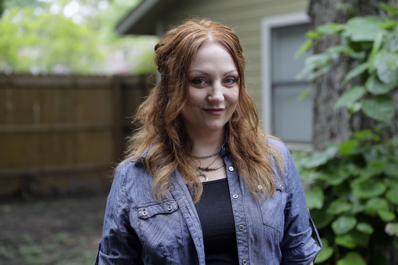 In this Tuesday, May 23, 2017, photo, Dawn Erin poses for a photo at her home, in Austin, Texas. Erin was among more than 20 million Americans who gained coverage under Affordable Care Act. The health law helped push uninsured rates to historic lows and also aimed to bring the newly insured back into the primary care system to improve their health. (AP Photo/Eric Gay)