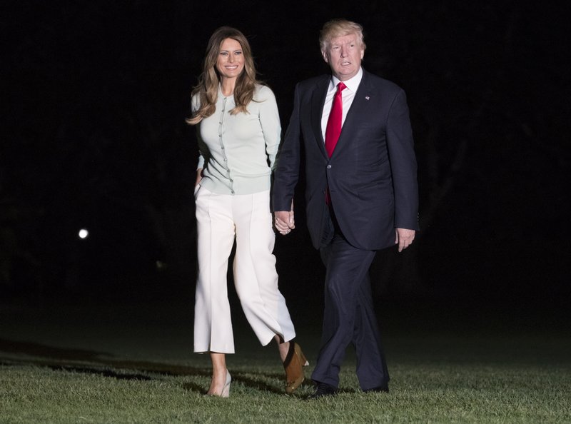 President Donald Trump and first lady Melania Trump walk from Marine One across the South Lawn to the White House in Washington, Saturday, May 27, 2017, as they return from Sigonella, Italy. (AP Photo/Carolyn Kaster)