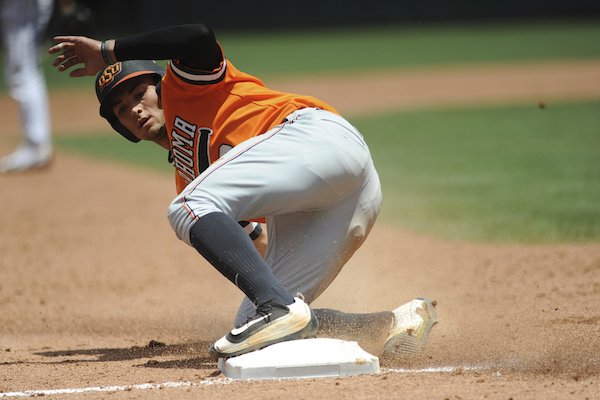 Oklahoma State's Garrett McCain slides safely into third in the championship game in the Big 12 baseball tournament in Oklahoma City, Sunday, May 28, 2017. (AP Photo/Kyle Phillips)
