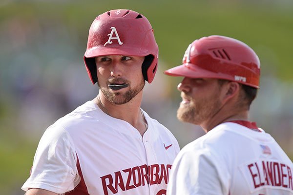 Arkansas first baseman Chad Spanberger talks with volunteer coach Josh Elander during an SEC Tournament game against LSU on Sunday, May 28, 2017, in Hoover, Ala. 