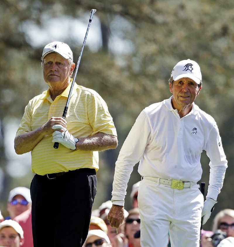 Gary Player, right, watches Jack Nicklaus' tee from the first hole during the par three competition before the Masters golf tournament Wednesday, April 10, 2013, in Augusta, Ga. 