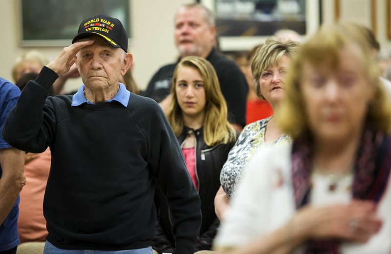 Cliff Stolpe of Bella Vista, an Army veteran in World War II, salutes as the colors are posted Monday during the Memorial Day Program at Bella Vista’s American Legion post.