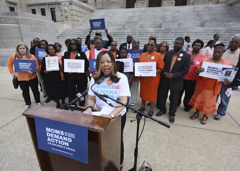 In this March 17, 2016, file photo, Lucy McBath, National Spokeswoman for Moms Demand Action for Gun Sense in America, is joined by faith leaders, gun violence survivors and others on the south steps of the Mississippi State Capitol in Jackson, Miss. 