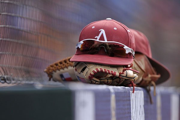 An Arkansas baseball hat sits atop a glove in the dugout prior to an SEC Tournament game against LSU on Sunday, May 28, 2017, in Hoover, Ala. 