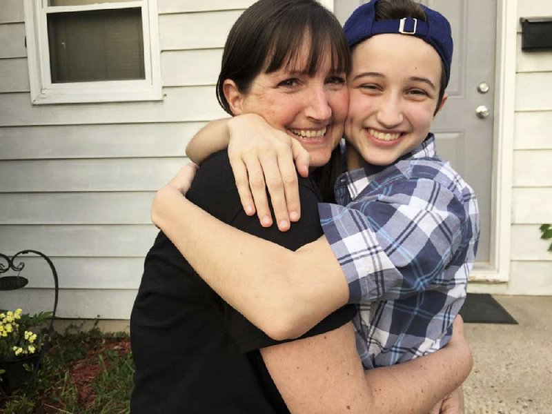 Ashton Whitaker (right), a transgender student who identifies as a male, hugs his mom Melissa in Kenosha, Wis., in this undated photo. 