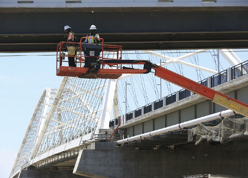 Arkansas Democrat-Gazette/STATON BREIDENTHAL --5/30/17-- Work continues Tuesday afternoon on the pedestrian and bike ramp from the new Broadway Bridge into Riverfront Park in North Little Rock.