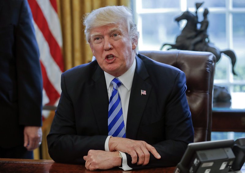 FILE - In this March 24, 2017, file photo President Donald Trump speaks in the Oval Office of the White House in Washington. Trump has been handing out his cellphone number to world leaders and urging them to call him directly, an unusual invitation that breaks diplomatic protocol and is raising concerns about the security and secrecy of the U.S. commander in chief's communications. (AP Photo/Pablo Martinez Monsivais, File)