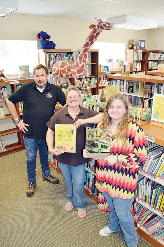 Conway County Library Director Jay Carter, from left, Assistant Director Denise Burton and student worker Kristina Scroggins stand in the children’s section of the library in Morrilton. They are working to prepare for a Friends of the Conway County Library Book Sale, which will take place June 8-10 at the former Magie Ford building, 1207 E. Harding St. Donations will be accepted there from 10 a.m. to 1 p.m. Monday and Tuesday.