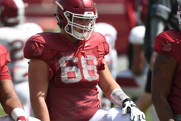 Arkansas offensive lineman Kirby Adcock stretches prior to a practice Saturday, April 15, 2017, in Fayetteville. 