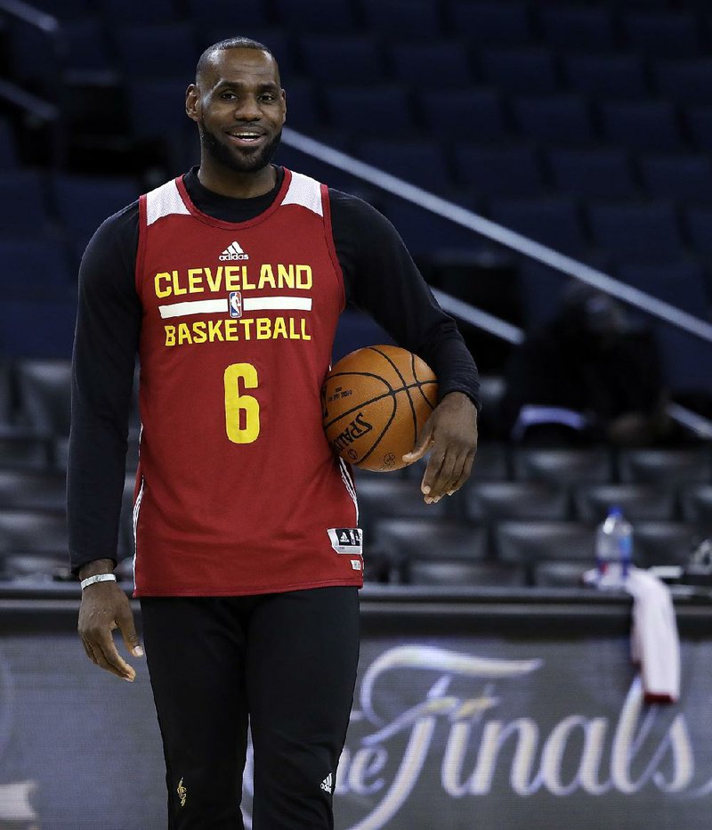 Cleveland Cavaliers' LeBron James holds a ball during an NBA basketball practice, Wednesday, May 31, 2017, in Oakland, Calif. 