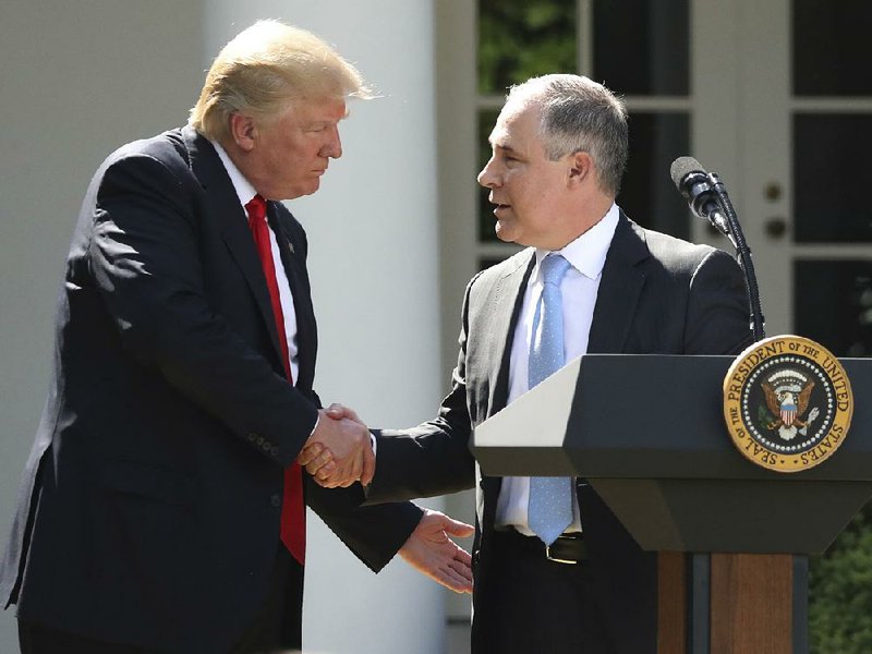 President Donald Trump yields the lectern to EPA Administrator Scott Pruitt after speaking Thursday in the White House Rose Garden about the United States’ role in the Paris climate agreement.