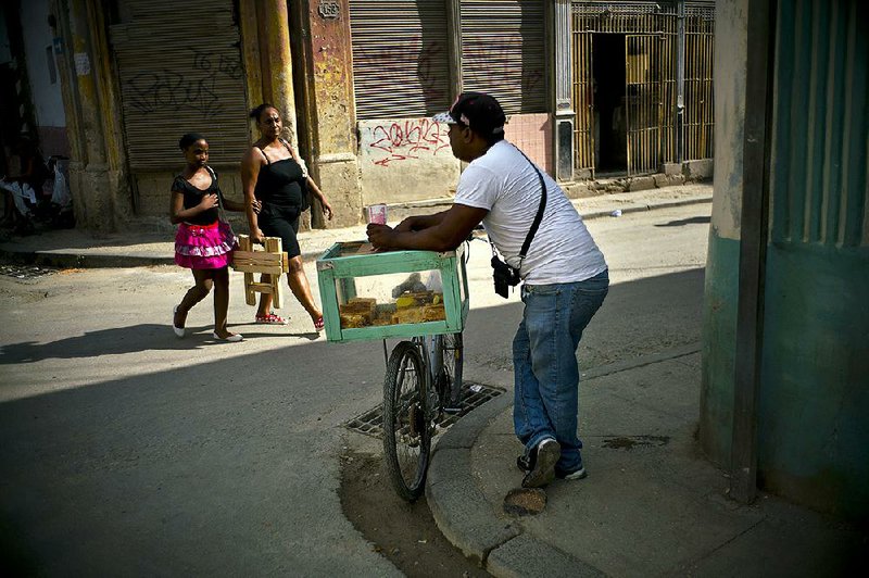 A pastry vendor works a street corner in Havana on Wednesday. Private businessmen in Cuba are recognized only as “self-employed,” a status with few legal protections. 