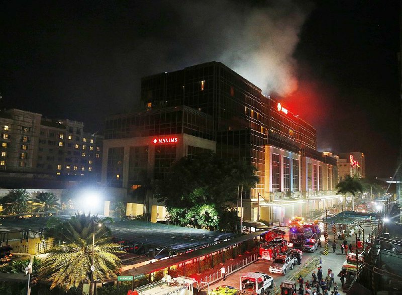 Smoke rises from the Resorts World Manila complex in the Philippines capital after an attack early today by a masked gunman.