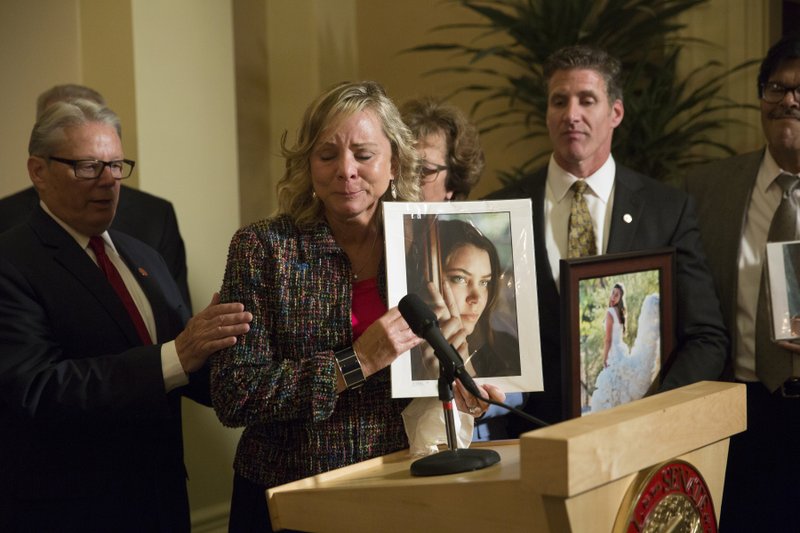 FILE - In this Sept. 11, 2015 file photo, Debbie Ziegler, mother of Brittany Maynard, speaks to the media after the passage of legislation, which would allow terminally ill patients to legally end their lives, at the state Capitol, in Sacramento, Calif. The law passed in California after 29-year-old Maynard, who was dying from brain cancer, had to move to Oregon in 2014 so she could end her life. (AP Photo/Carl Costas)