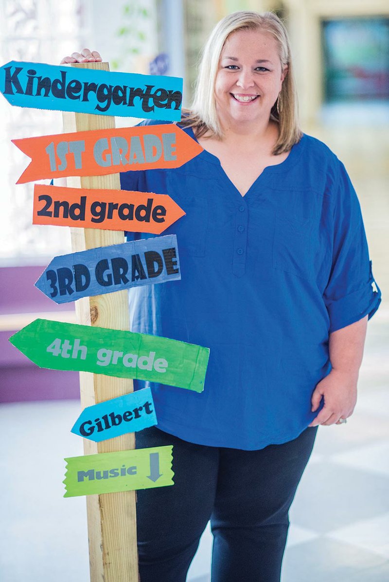 Randi House stands by a sign in the hallway at Theodore Jones Elementary School in Conway, where she teaches kindergarten. House, 36, was named Conway School District Teacher of the Year for 2018. Principal Tammy Woosley called House a phenomenal teacher.