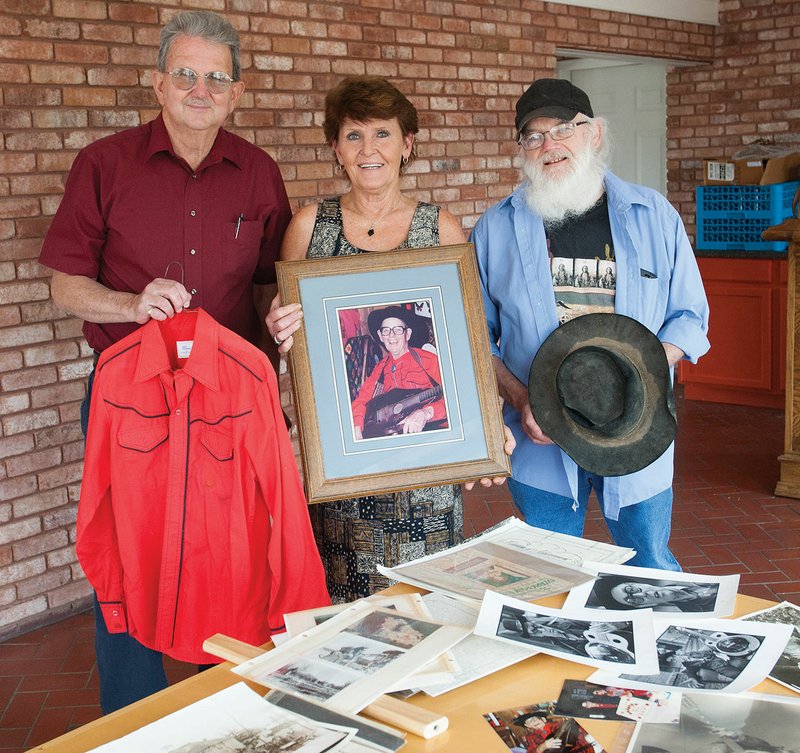 From left, Ron C. Helm, Debra Williams and Mark Jones hold memorabilia that belonged to legendary singer Jimmy Driftwood. The three are spearheading a benefit concert, set for June 11, to raise money for a statue of Driftwood that will be placed at Pickett Park in Mountain View. The cost of the statue is $38,000. 