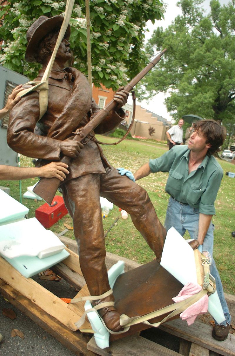 City workers remove the Capital Guards statue from its pedestal in MacArthur Park on Tuesday in preparation for relocation to Two Rivers Park. Fayetteville-born Otus the Head Cat’s award-winning column of humorous fabrication appears every Saturday.