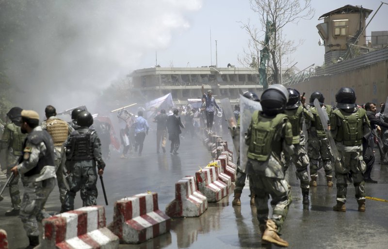 Protesters throw stones at police during a demonstration in Kabul, Afghanistan, on Friday, June 2, 2017. Hundreds of demonstrators demanded better security in the Afghan capital in the wake of a powerful truck bomb attack that killed scores of people. 
