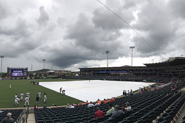 A tarp covers the field at Baum Stadium during a rain delay prior to a game between Oklahoma State and Oral Roberts on Saturday, June 3, 2017, in Fayetteville. 