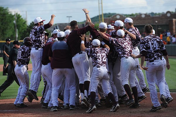 Missouri State players celebrate at home plate after Jeremy Eierman hit a game-winning home run in the ninth inning of an NCAA Tournament game against Oklahoma State on Friday, June 2, 2017, in Fayetteville. 