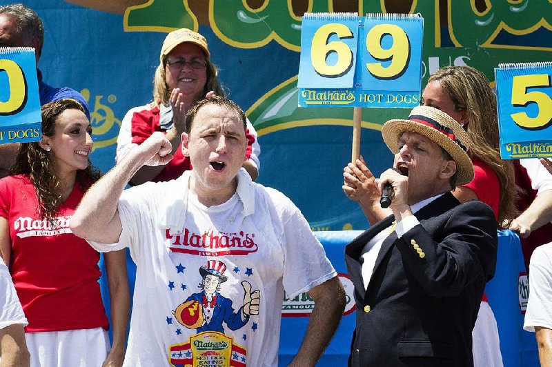 Joey Chestnut (foreground) is nervous about participating in today’s ice cream sandwich eating contest in San Diego because too much ice cream numbs the mouth and affects a body’s core temperature.