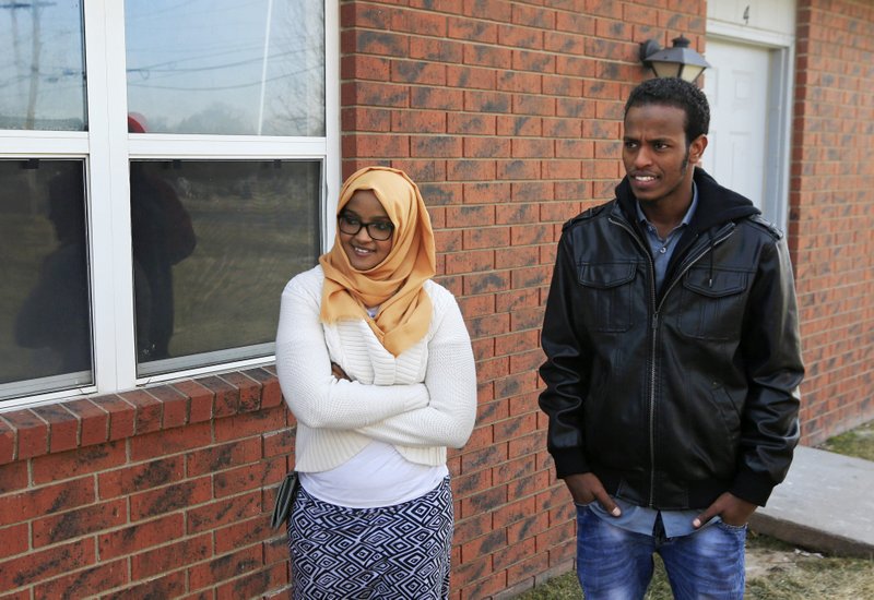 FILE - In this Feb. 3, 2017, file photo, Ifrah Ahmed, left, and Mursal Naleye stand outside a new walk-in clinic in Garden City, Kan. Kansas is launching a project to help immigrants in the meatpacking town get driver's licenses by offering them free translators when they take their exams. Naleye, who is from Somalia, is a volunteer in the pilot project, and Ahmed, who came to Kansas in 2012 from Kenya, plans to volunteer for the program. 