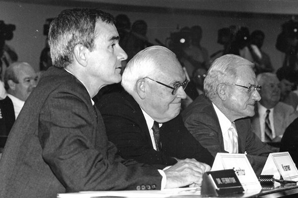 Arkansas chancellor Dan Ferritor, SEC commissioner Roy Kramer and Arkansas athletics director Frank Broyles listen during a University of Arkansas Board of Trustees meeting on Aug. 1, 1990, at which the Razorbacks were invited to join the SEC. 