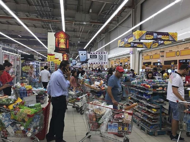 Shoppers stock up on supplies at a supermarket Monday in Doha, Qatar, after Saudi Arabia closed its land border with Qatar, through which the tiny Gulf nation imports most of its food.