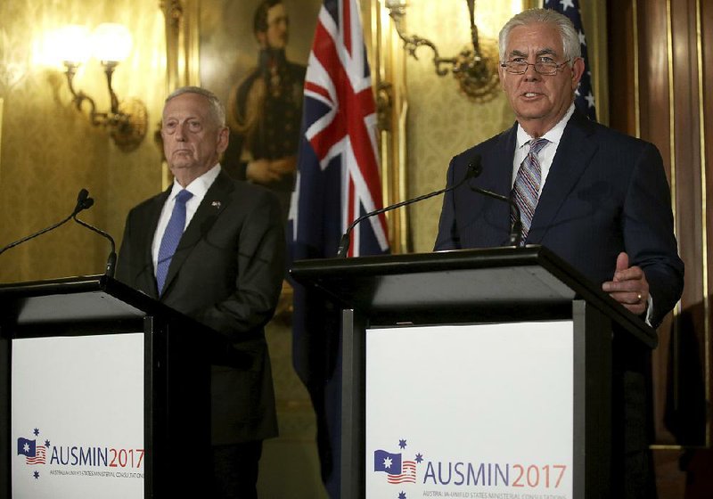 U.S. Defense Secretary James Mattis (left) listens as U.S. Secretary of State Rex Tillerson speaks at a news conference with their Australian counterparts in Sydney on Monday.