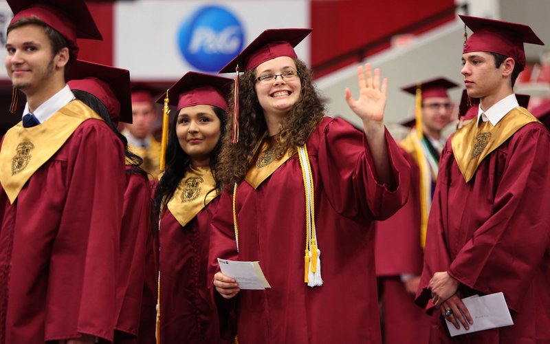 Joann James, a graduating senior waves Wednesday, May 17, 2017, as she enters Barnhill Arena for graduation ceremonies of Rogers New Technology High School on the campus of the University of Arkansas in Fayetteville. The graduating class is the first to complete all four years at the school.