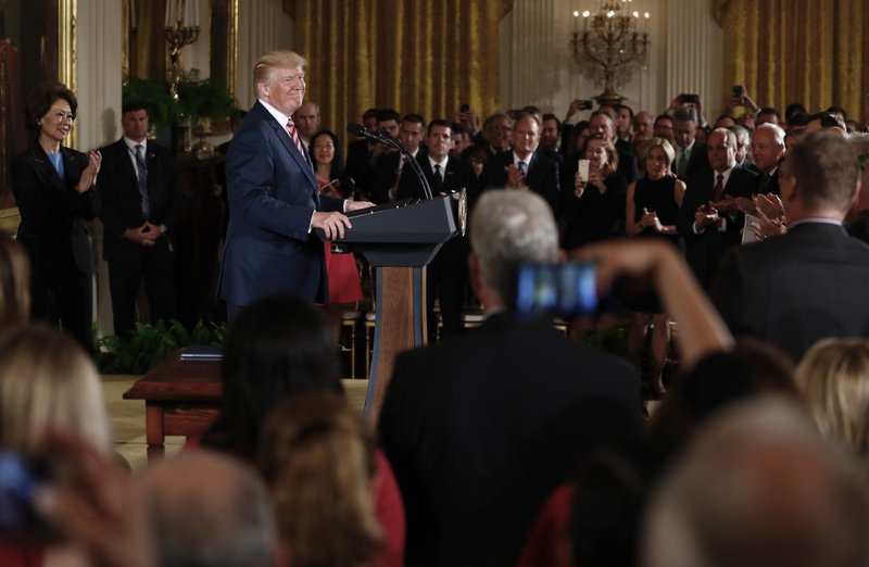 President Donald Trump pauses as the audience stands and applauds as he speaks in the East Room of the White House in Washington, Monday, June 5, 2017, to announce plans to privatize the nation's air traffic control system. (AP Photo/Carolyn Kaster)