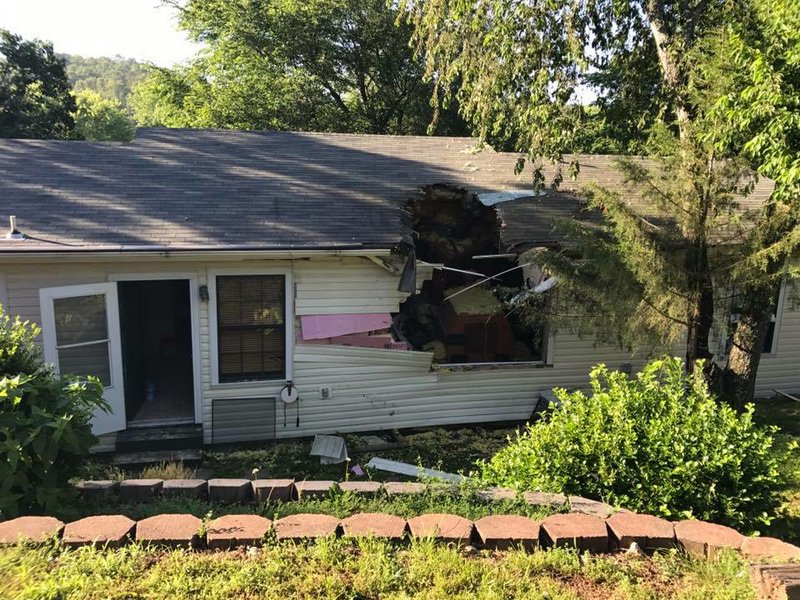 A street sweeper crashed into a Benton County home Tuesday and pinned a woman and baby underneath.