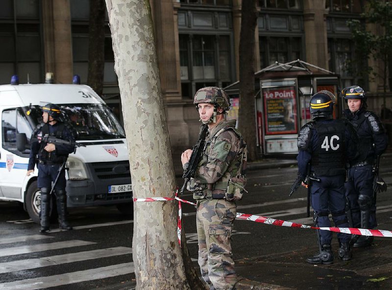 Police and soldiers seal off access to Paris’ Notre Dame Cathedral on Tuesday after an attack on officers guarding the church. 