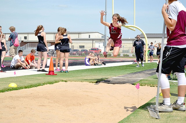Annette Beard Special to the Enterprise-Leader/Lincoln junior Madison Jones takes off during long jump competition during the 4A-1 Conference track and field meet hosted by Pea Ridge April 25. Jones placed third for Lincoln with a mark of 14-8.5.