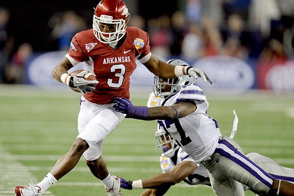 Arkansas wide receiver Joe Adams (3) is pushed out of bounds by Kansas State defensive back David Garrett (27) and defensive back Emmanuel Lamur (23) during the second half of the Cotton Bowl NCAA college football game, Friday Jan. 6, 2012 in Arlington, Texas. Arkansas won 29-16. (AP Photo/Matt Strasen)
