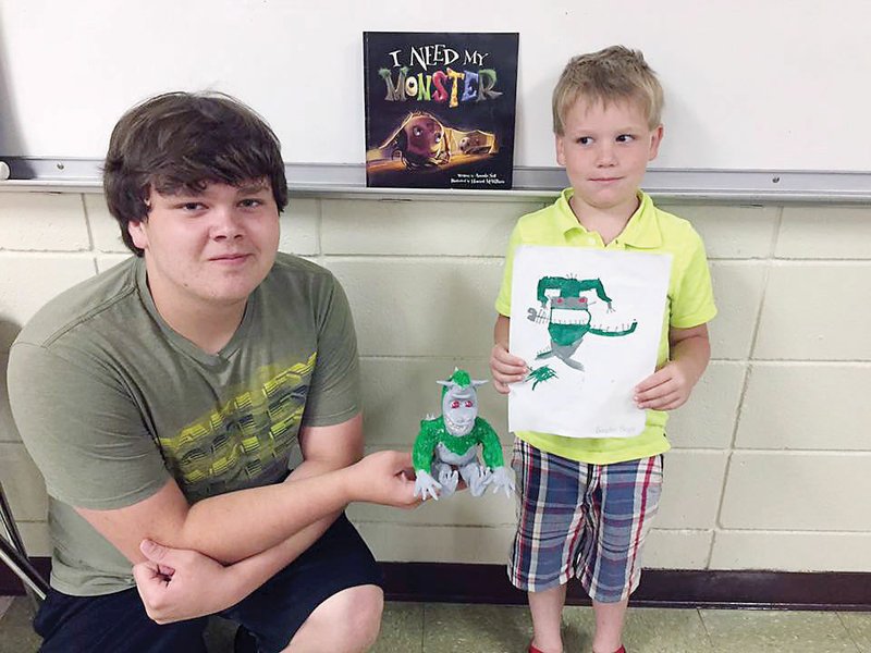 From left, Darian and Braden Boyce, students of Quitman art teacher Leanne Colvin, show off their artwork — Braden’s drawing and Darian’s clay monster. Colvin’s Big Monster, Little Monster project involved teaming up Quitman High school students with first-graders from Quitman Elementary School. The high school student read a monster-themed children’s book to the first-grader, who then drew a monster from the book; then the high school student molded the monster from clay.