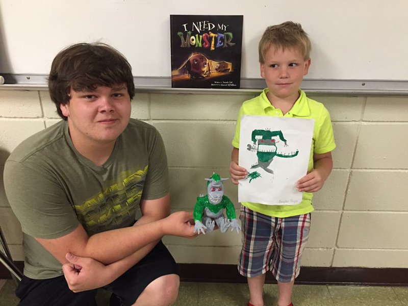 Darian, left, and Braden Boyce, students of Quitman art teacher Leanne Colvin, show off their artwork — Braden’s drawing and Darian’s clay monster. Colvin’s Big Monster, Little Monster project involved teaming up Quitman High school students with first-graders from Quitman Elementary School. Each high school student read a monster-themed children’s book to a first-grader, who then drew a monster from the book; then the high school student molded the monster from clay.