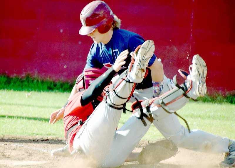 Photo by Rick Peck McDonald County catcher Joe Brown drops the ball while being run over by a Joplin runner, but McDonald County gets the out call due to runner&#8217;s failure to slide. Joplin clamed a 3-2 win in the regular season game on May 31 at MCHS.