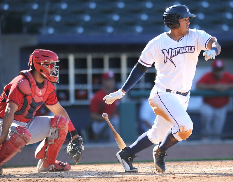 NWA Democrat-Gazette/ANDY SHUPE Northwest Arkansas Naturals first baseman Samir Duenez (right) connects with the ball Wednesday against Springfield at Arvest Ballpark in Springdale. Visit nwadg.com/photos for more photographs from the game.