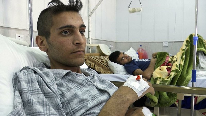 “There were bullets falling on us like rain,” Riyadh Abdullah said from a hospital bed in Irbil, Iraq, as he recounted gunmen firing on his family members when they tried to leave their home in Mosul last week. 