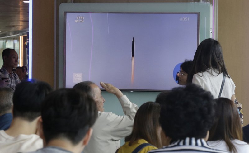 People watch a TV news program showing a file footage of a missile launched by North Korea, at Seoul Railway Station in Seoul, South Korea, Thursday, June 8, 2017. North Korea fired several projectiles believed to be short-range surface-to-ship cruise missiles off its east coast Thursday, South Korea's military said, a continuation of weapons tests that have rattled Washington and the North's neighbors as Pyongyang seeks to build a nuclear missile capable of reaching the continental United States. (AP Photo/Ahn Young-joon)