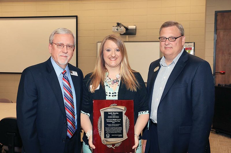 Greenbrier Middle School Principal Kelli McGaha-Martin stands with Mike Mertens, left, assistant executive director of the Arkansas Association of Educational Administrators, and Greenbrier Superintendent Scott Spainhour after she received the Middle-Level Principal of the Year award.