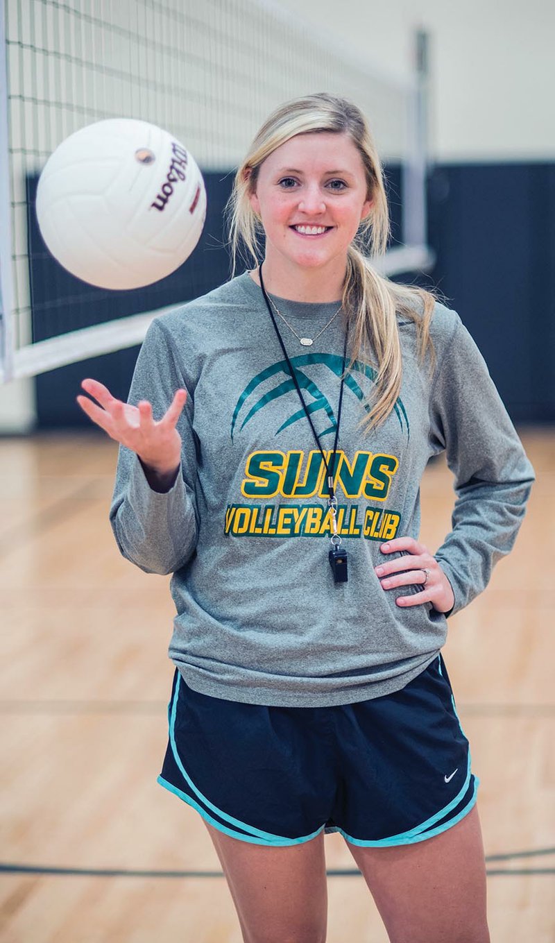 Kaci Posey tosses a volleyball in the Dover Middle School gymnasium as she prepares for the first day of practice as coach of the new girls volleyball team. Posey is a former volleyball player for the Arkansas Tech University Golden Suns in Russellville.