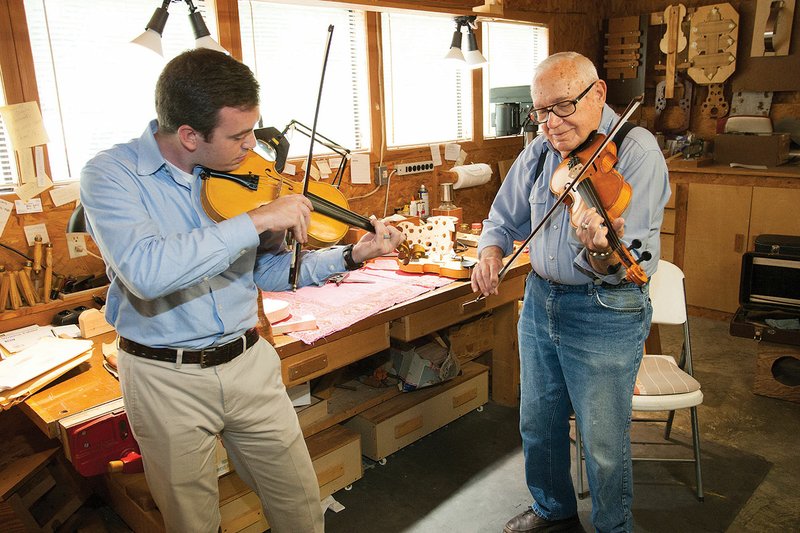 Eric Gomance, left, and Phil Wingfield play music on the violins Wingfield made by hand. Gomance, who lives in Hot Springs, has spent more than 200 hours as an apprentice to Wingfield.