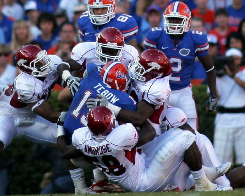 Several Arkansas defenders take down Florida quarterback Tim Tebow (center) during their game on Oct. 17, 2009. Tebow was sacked 6 times, but he accounted for 324 yards of total offense and 1 passing touchdown in the Gators’ 23-20 victory.