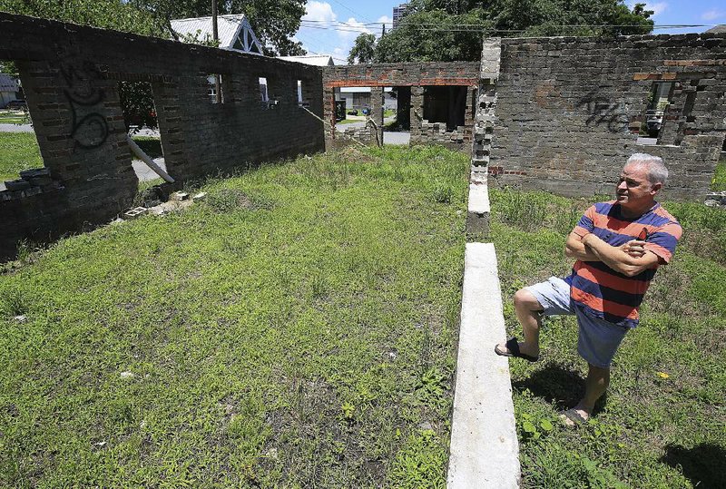 Realtor Tony Curtis walks through “The Ruins” at 305 W. 13th St. in Little Rock last week. Curtis prefers to call it an “unfinished structure.” 