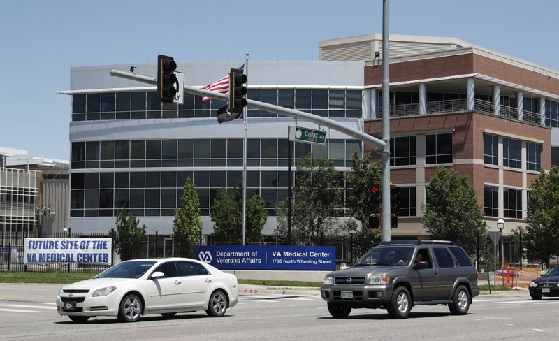 Traffic passes by the campus of the Veterans Administration hospital under construction Thursday, June 8, 2017, in Aurora, Colo. On Thursday, June 8, the United States Justice Department announced that it has declined to prosecute Veterans Affairs Department executives after lawmakers accused two of them of misleading Congress about massive cost overruns at the Aurora, Colo., site. (AP Photo/David Zalubowski)