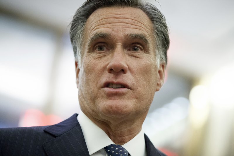FILE - In this Tuesday, Nov. 29, 2016 file photo, former Republican presidential nominee Mitt Romney talks with reporters in New York.