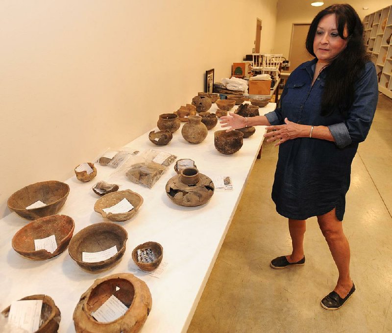 Carrie Wilson, a representative of the Quapaw tribe, speaks Wednesday at the Arkansas Archeological Survey in Fayetteville about a collection of funerary pottery from around the year 1200. The survey has returned items recovered from sites in Arkansas to several tribes, including the Quapaw. 