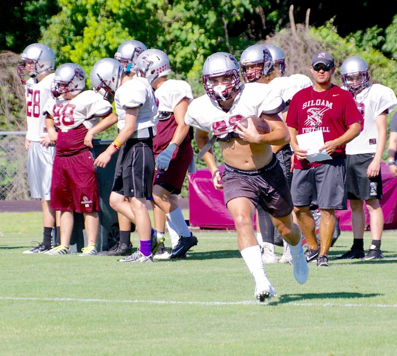 Randy Moll/Westside Eagle Observer Siloam Springs junior running back Kaiden Thrailkill carries the ball during a portion of a team camp held Tuesday morning at Pioneer Stadium in Gentry. The Panthers are scheduled to compete Thursday in a team camp at Fayetteville.